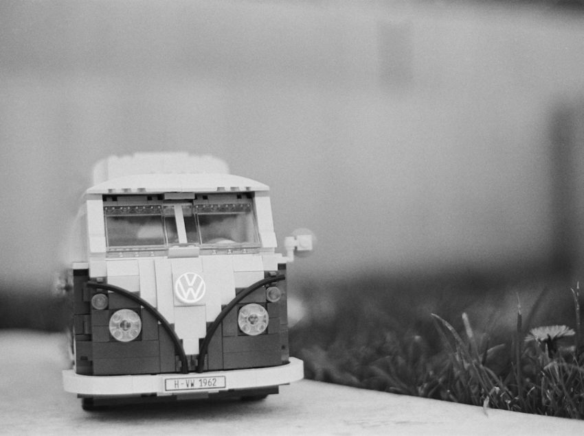 lego vw bus camper van small scale with dandelion next to it 
