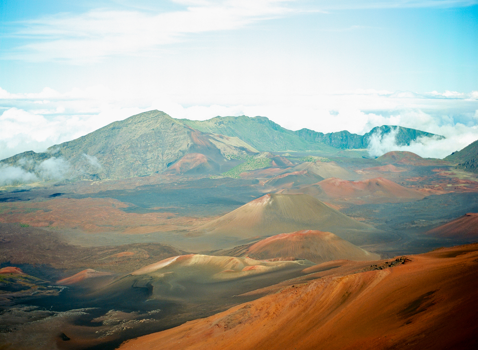 View into Haleakala Crater full of rust and earth colors