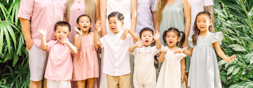 Family dressed up in pastel colors for photo session on Hawaii