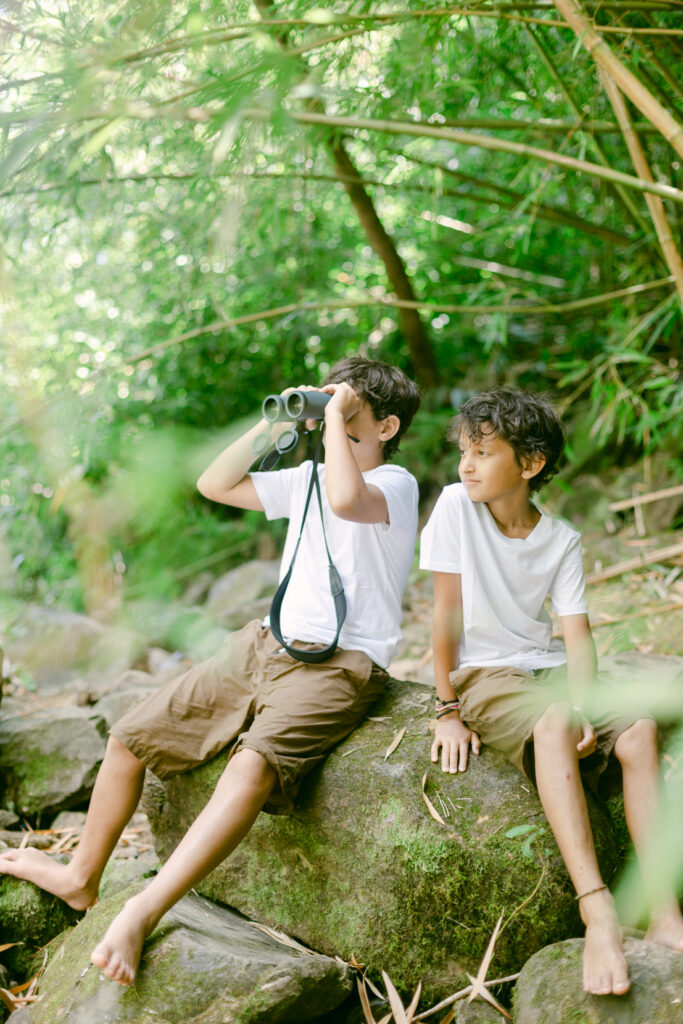 Kids posing with binoculars on Hana waterfall bamboo forest hike