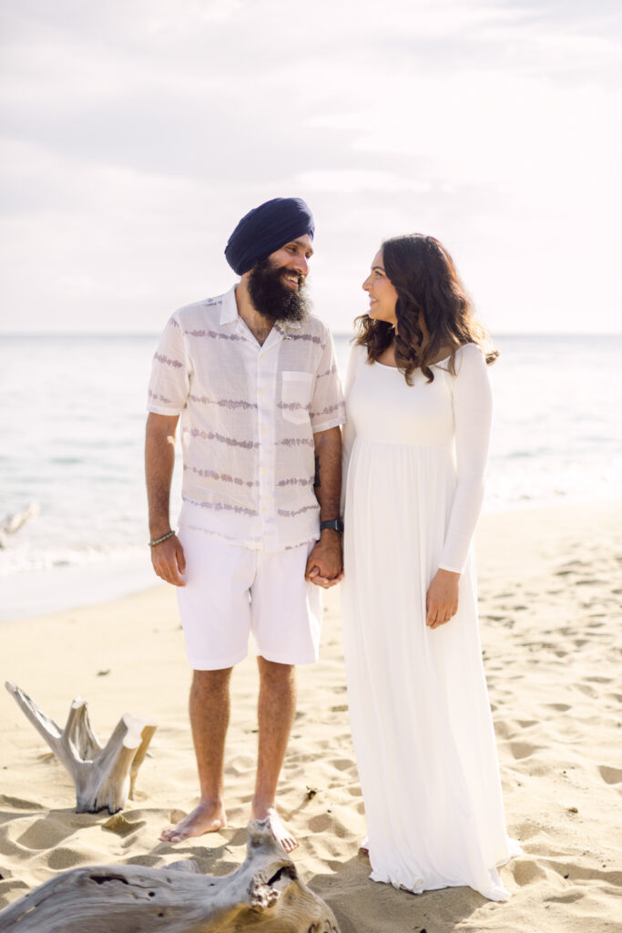 Maui babymoon photography session on a beach with driftwood