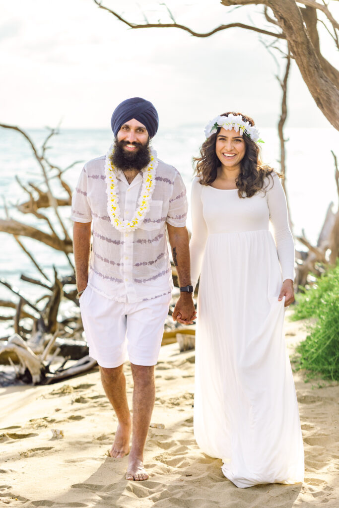 Couple with lei on beach for sunset maternity babymoon photography
