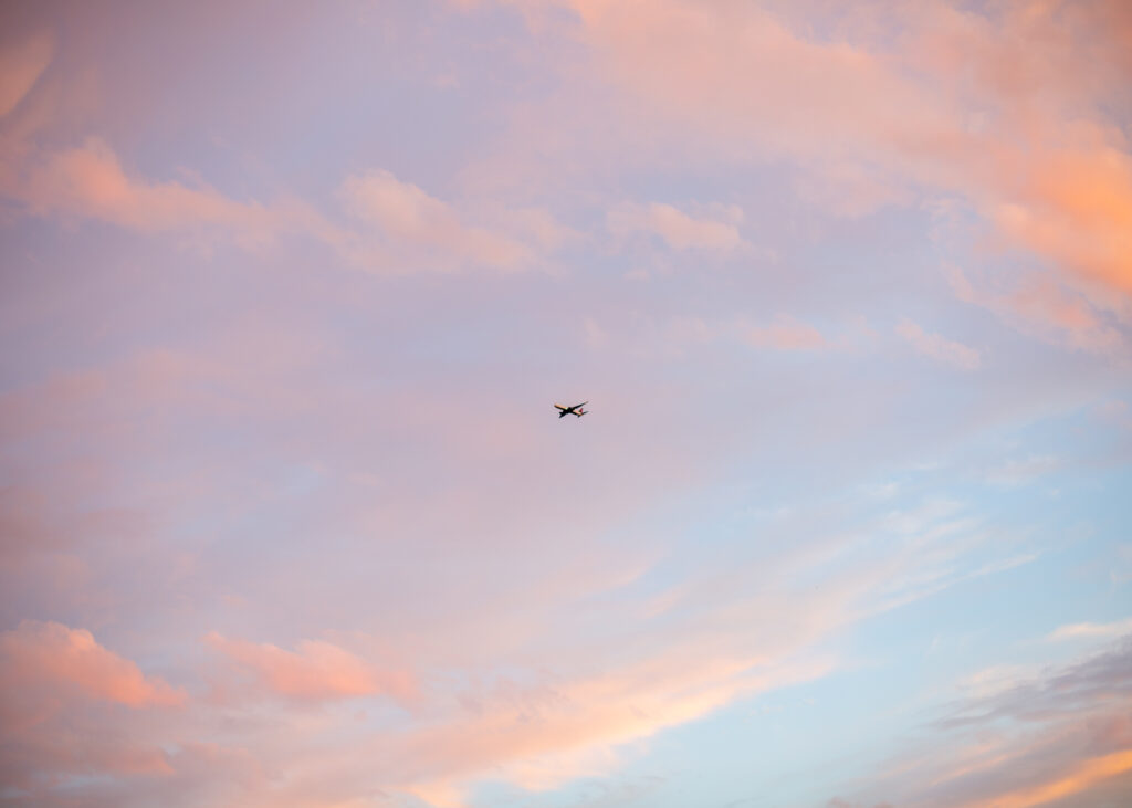 airplane in pastel sky