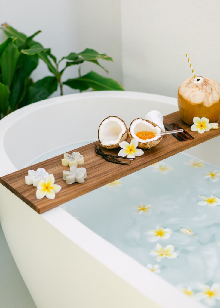 Outdoor plumeria flower bath during a Maui babymoon prenatal spa experience