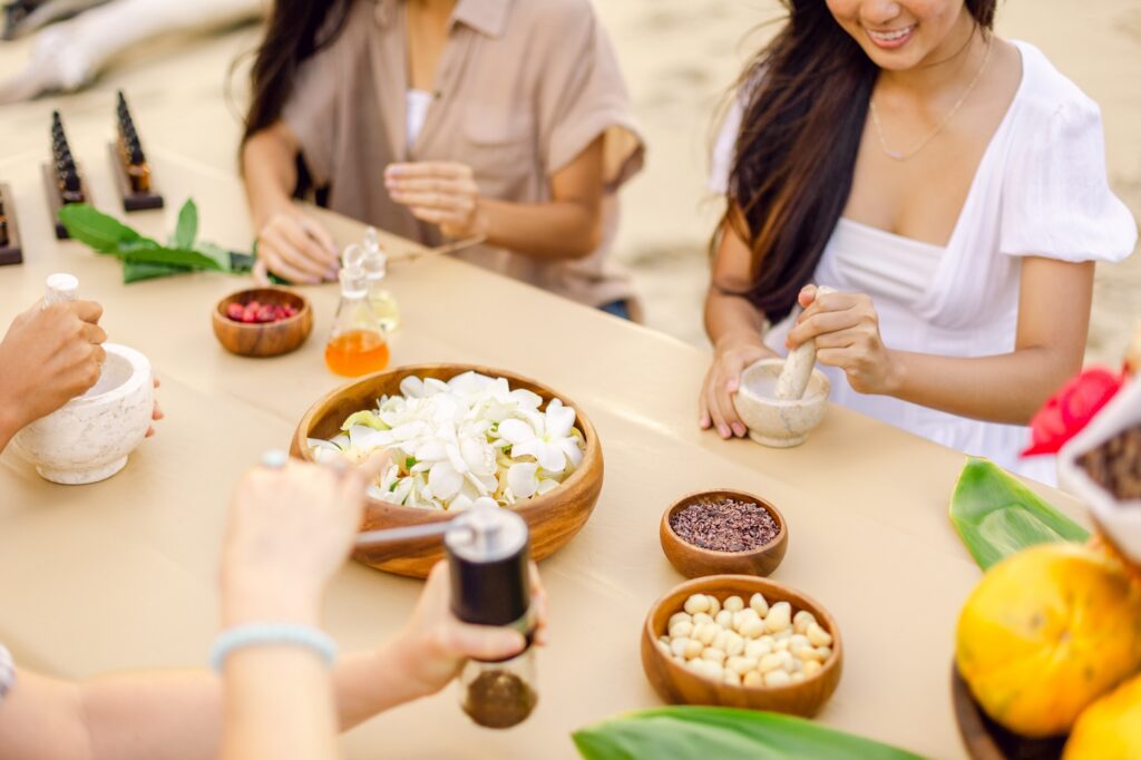 Making handmade body butter with fresh ingredients during a Maui prenatal self-care workshop