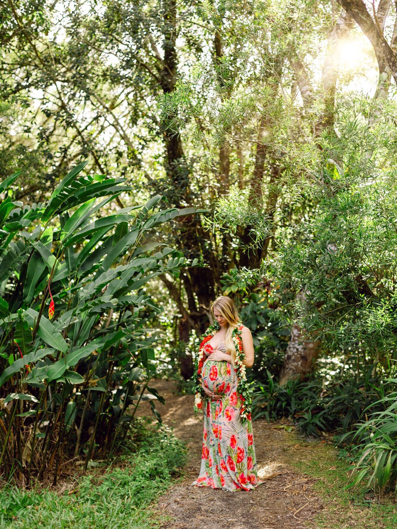 Pregnant woman on a gentle hike at Twin Falls in Maui during a babymoon photo session