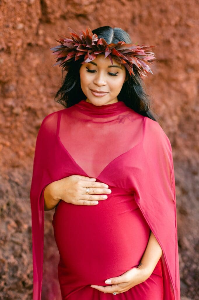 Maternity photos Maui black sand beach red cliffs bold styling lei