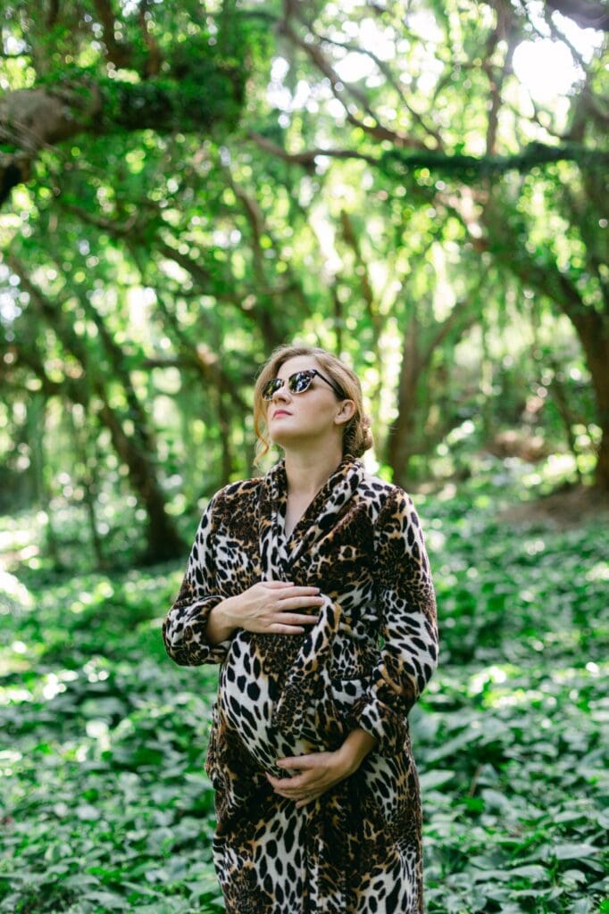 Maui maternity session in Honolua rainforest with expectant mother in leopard robe and sunglasses