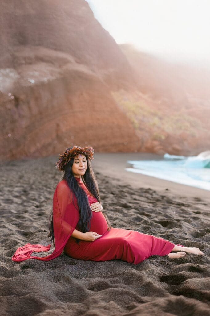 Black sand beach maternity session Maui turquoise water volcanic coast