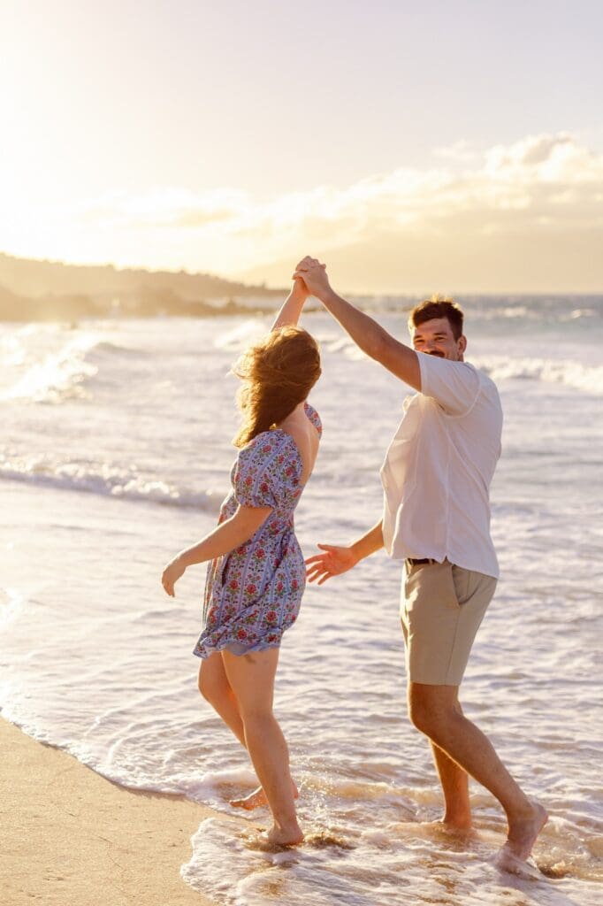 happy maui family reunion photos dancing at beach during sunset
