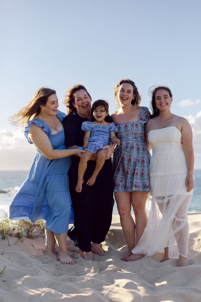 maui family reunion trip sisters and daughters happy on the beach with baby on the way 